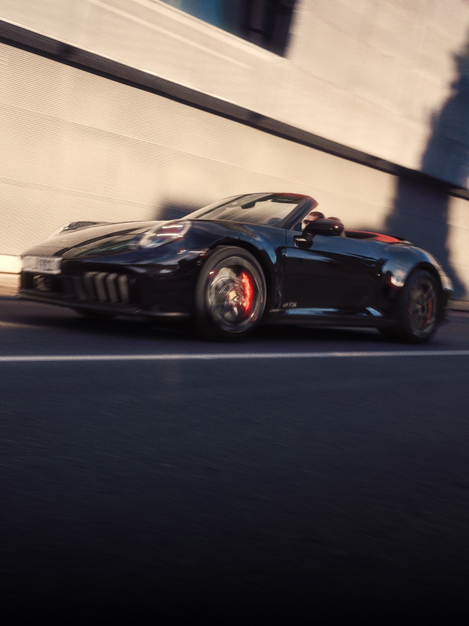 Ein Porsche 911 fährt eine Strasse hinunter.